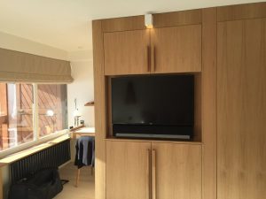 Mur de la chambre avec télé encastrée et spot carré blanc